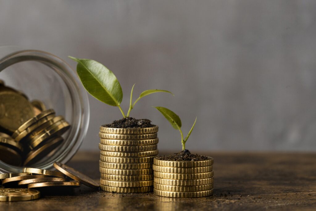 front view two stacks coins with jar plants
